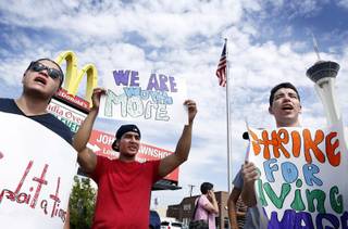 Mcdonald's employees Salavador Hernandez, from left, Jorge Martinez and Socrates Garcia protest for higher wages in front of a McDonald's on the corner of Paradise Road and Sahara Avenue in Las Vegas on Thursday, August 29, 2013.