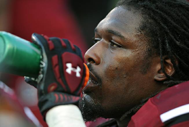 South Carolina Gamecocks defensive end Jadeveon Clowney (7) drinks from a water bottle on the sideline during the first half of an NCAA college football game against North Carolina, Thursday, Aug. 29, 2013 in Columbia, S.C. 