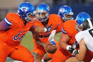 Bishop Gorman quarterback Randall Cunningham looks to hand off to a teammate during Gorman's 41-17 win over Servite Friday, August 30, 2013.