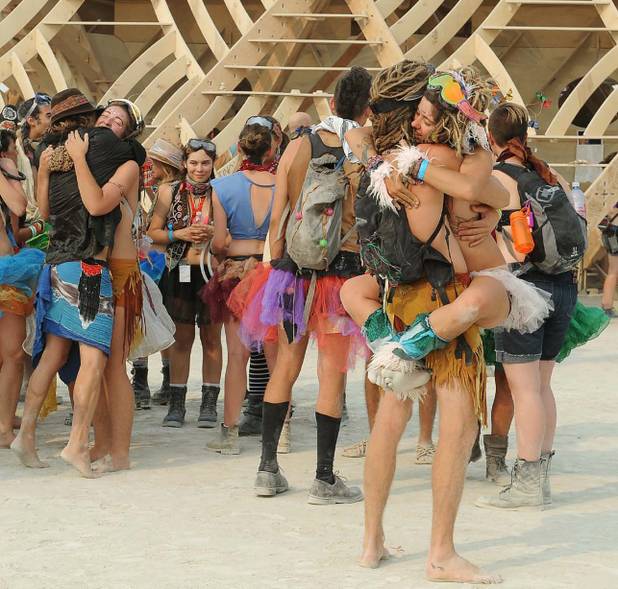 In this Wednesday, Aug. 28, 2013, photo, people gather outside a temple art structure at Burning Man in Gerlach, Nev. Once a year, tens of thousands of participants gather for Burning Man in Nevada's Black Rock Desert to create Black Rock City, dedicated to community, art, self-expression and self-reliance. 