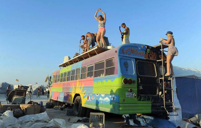 In this Thursday, Aug. 29, 2013, photo, a band plays on top of a bus at Burning Man in Gerlach, Nev. Once a year, tens of thousands of participants gather for Burning Man in Nevada's Black Rock Desert to create Black Rock City, dedicated to community, art, self-expression and self-reliance. 