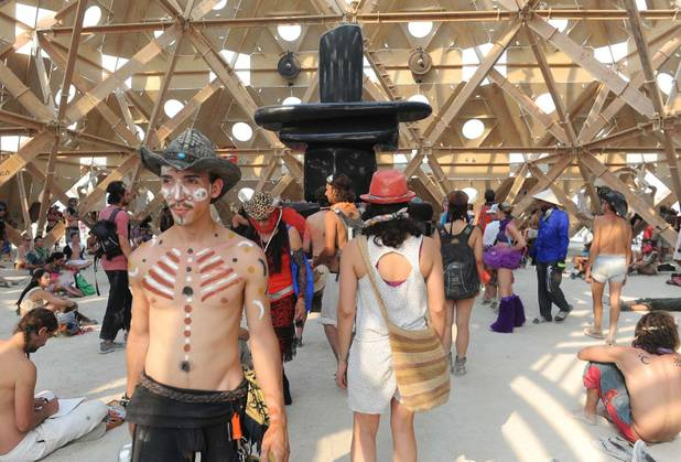 In this Wednesday, Aug. 28, 2013 photo, people gather inside a temple at Burning Man in Gerlach, Nev. Once a year, tens of thousands of participants gather for Burning Man in Nevada's Black Rock Desert to create Black Rock City, dedicated to community, art, self-expression and self-reliance. 