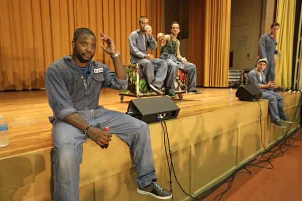 In this Aug. 27, 2013, photo, from left, rappers Postell Pringle, JQ and GQ, DJ Clayton Stamper, and rapper Jackson Doran take questions from the audience at the Cook County Jail after performing a 70 minute hip hop adaptation of William Shakespeare's Othello, titled "Othello: The Remix" at the Cook County Jail in Chicago. 