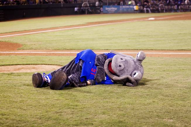 The 51s Alien mascot lies on the ground during their game against Tuscon, Saturday, Aug. 31, 2013. The 51s won the Pacific Coast League Southern Division title beating Tuscan 8-6.