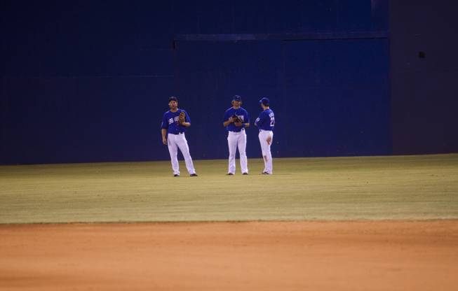 51s outfielders from left, Jamie Hoffman, Kirk Nieuwenhuis and Mike Baxter talk during a time out at the beginning of the sixth inning. The 51s went on to win the Pacific Coast League Southern Division title beating Tuscan 8-6, Saturday, Aug. 31, 2013.