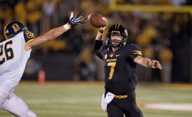 Missouri quarterback Maty Mauk, right, throws the ball past Murray State's Demetric Johnson during the fourth quarter of an NCAA college football game Saturday, Aug. 31, 2013, in Columbia, Mo. Missouri won the game 58-14. 