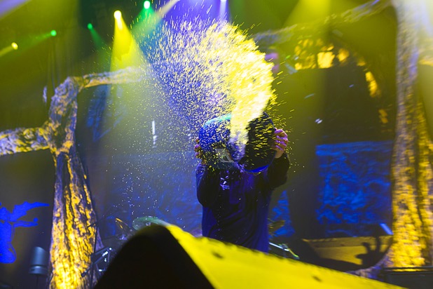 Ozzy Osbourne throws water from a bucket during the Black Sabbath concert at MGM Grand Garden Arena on Sunday, Sept. 1, 2013.