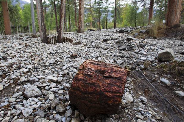 Storm derbies is shown after heavy storm runoff tore through the Rainbow Canyon subdivision on Mount Charleston Sunday, Sept. 1, 2013.