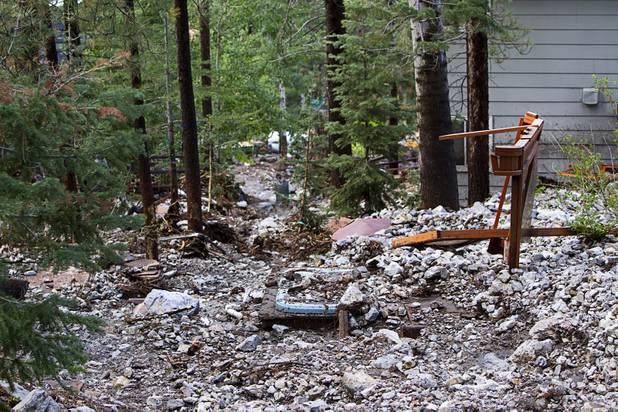 What appears to be the remains of a gazebo is shown in a yard after heavy storm runoff tore through the Rainbow Canyon subdivision on Mount Charleston Sunday, Sept. 1, 2013.