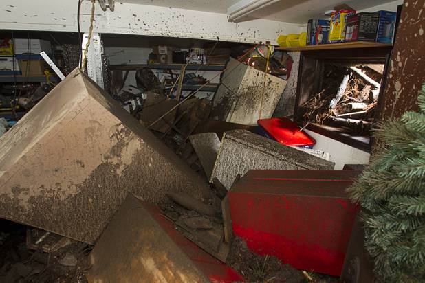 Damage is shown to the workshop of Duffy Grismanauskas after heavy storm runoff tore through the Rainbow Canyon subdivision on Mount Charleston Sunday, Sept. 1, 2013.