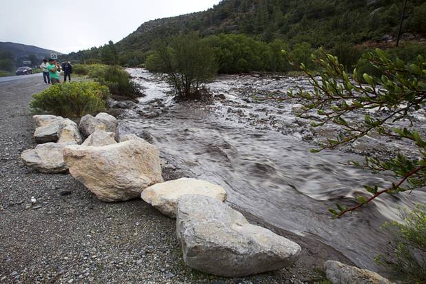 Storm runoff flows along Kyle Canyon Road near Highway 158 on Mount Charleston Sunday, Sept. 1, 2013. Kyle Canyon Road was temporarily closed at Highway 158 after heavy storm runoff tore through the Rainbow Canyon subdivision.