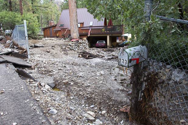A home is shown on Rainbow Canyon Boulevard after heavy storm runoff tore through the Rainbow Canyon subdivision on Mount Charleston Sunday, Sept. 1, 2013.
