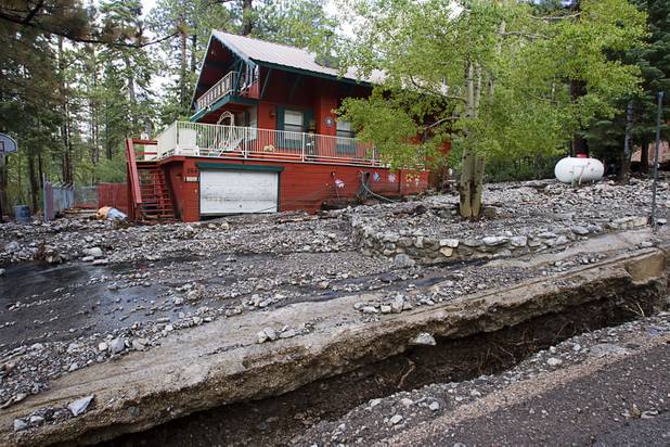 A home is shown on Rainbow Canyon Boulevard after heavy storm runoff tore through the Rainbow Canyon subdivision on Mount Charleston Sunday, Sept. 1, 2013.