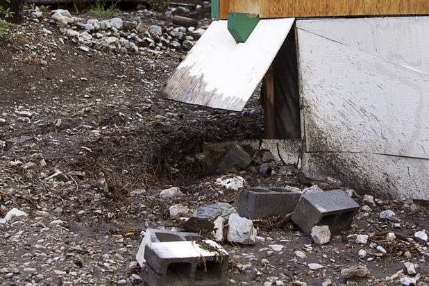 Damage to a home is shown after heavy storm runoff tore through the Rainbow Canyon subdivision on Mount Charleston Sunday, Sept. 1, 2013.