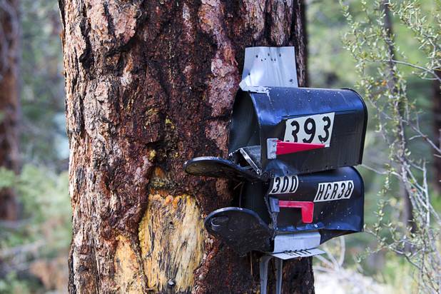 Mailboxes, crush by heavy storm runoff, are shown in the Rainbow Canyon subdivision on Mount Charleston Sunday, Sept. 1, 2013.