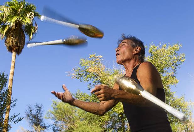 Nino Frediani, 73, juggles clubs in his backyard Tuesday, Sept. 3, 2013. The club heads are covered in gold tape so that he can see them better. Frediani has performed as a professional juggler in Las Vegas for more than 30 years but few people knew that he is legally blind.