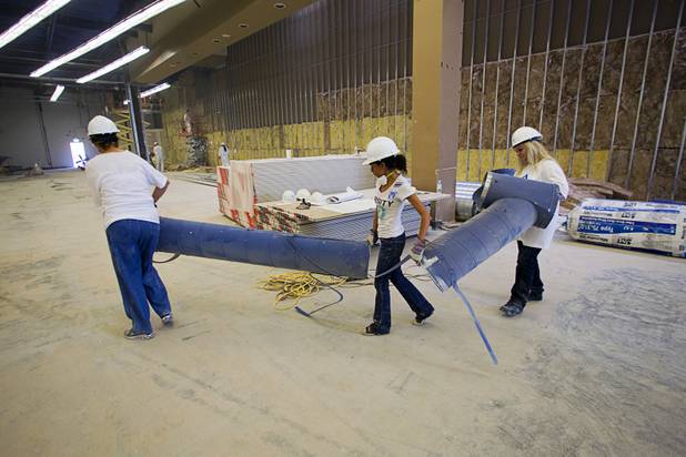 Volunteers from M&M's World Las Vegas and Ethel M Chocolates remove old ductwork at the new Habitat for Humanity ReStore at the old Tower Records store, 4580 W. Sahara Ave., Wednesday, Sept. 4, 2013. The project is part of M&M's campaign to encourage Americans to help MProve America through a national partnership with Habitat for Humanity. 