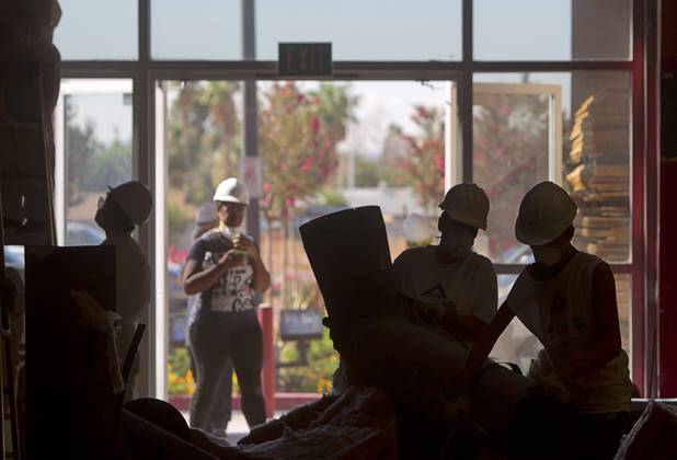 Volunteers from M&M's World Las Vegas and Ethel M Chocolates work to insulate walls at the new Habitat for Humanity ReStore at the old Tower Records store, 4580 W. Sahara Ave., Wednesday, Sept. 4, 2013. The project is part of M&M's campaign to encourage Americans to help MProve America through a national partnership with Habitat for Humanity. 