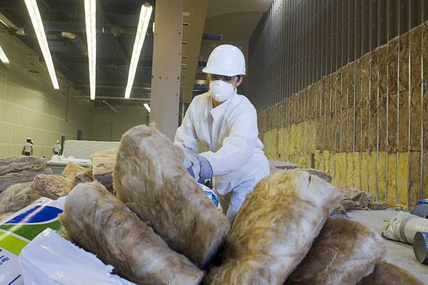Jessica Ruttman, a marketing manager at Ethel M Chocolates, cuts insulation at the new Habitat for Humanity ReStore at the old Tower Records store, 4580 W. Sahara Ave., Wednesday, Sept. 4, 2013. The project is part of M&M's campaign to encourage Americans to help MProve America through a national partnership with Habitat for Humanity. 