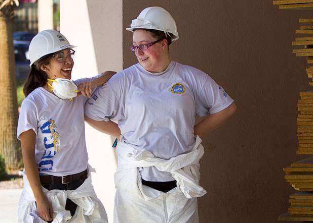Ethel M Chocolates associates Lauren Duenas, left, and Tracy Harvego take a break from volunteer work on the new Habitat for Humanity ReStore at the old Tower Records store, 4580 W. Sahara Ave., Wednesday, Sept. 4, 2013. The project is part of M&M's campaign to encourage Americans to help MProve America through a national partnership with Habitat for Humanity. 