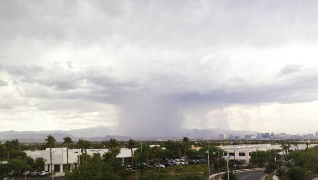 Rain falls over Red Rock Canyon on Friday afternoon, Sept. 6, 2013.
