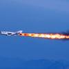 In this April 29, 2013, photo provided by Virgin Galactic, the company's SpaceShipTwo fires its rockets over Mojave, Calif., after it was dropped from its "mothership," WhiteKnightTwo.
