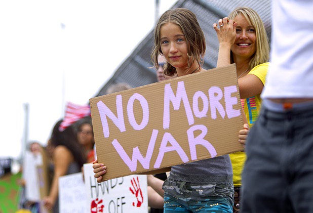 Marisa Schoepke, 12, pickets against proposed U.S. military action in Syria during a protest at the Tropicana Avenue overpass above I-15 Saturday, Sept. 7, 2013. About 50 people attended the protest.
