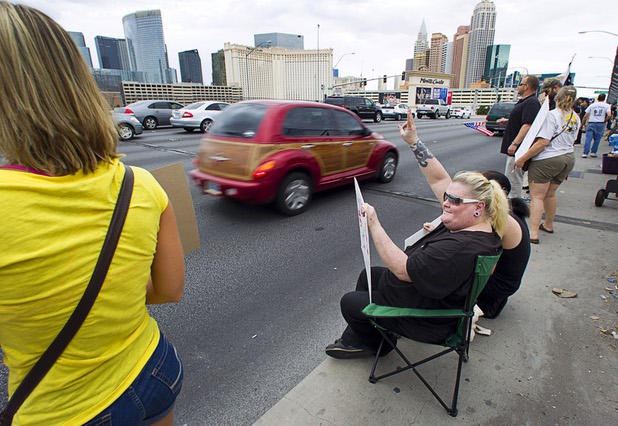 Jessicca Rigler-Ninn, center, expresses her opposition to proposed U.S. military action in Syria during a protest at the Tropicana Avenue overpass above I-15 Saturday, Sept. 7, 2013. About 50 people attended the protest.