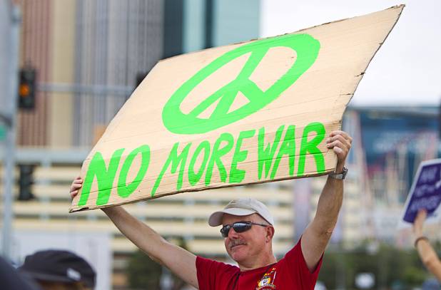 Stephen Davis expresses his opposition to proposed U.S. military action in Syria during a protest at the Tropicana Avenue overpass above I-15 Saturday, Sept. 7, 2013. About 50 people attended the protest.