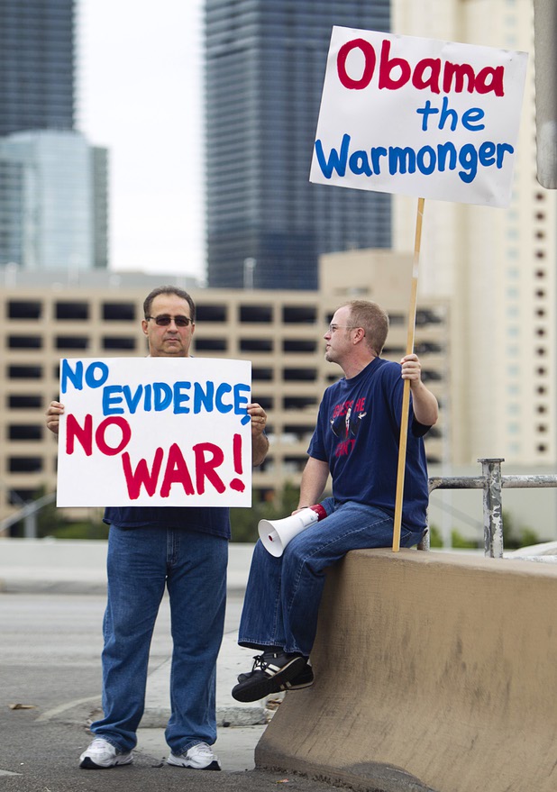Jimmy Barber, left, and Berry Johnston express their opposition to proposed U.S. military action in Syria during a protest at the Tropicana Avenue overpass above I-15 Saturday, Sept. 7, 2013. Barber is half-Syrian and his father is retired in Syria, he said.