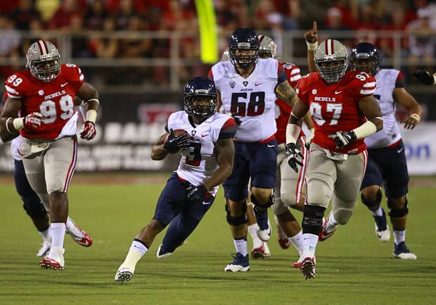 University of Arizona running back Daniel Jenkins finds a hole during UNLV's home opener against the University of Arizona at Sam Boyd Stadium Saturday, Sept. 7, 2013.