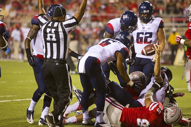 University of Arizona quarterback B.J. Denker holds up the ball after scoring his second touchdown during UNLV's home opener against the University of Arizona at Sam Boyd Stadium Saturday, Sept. 7, 2013.