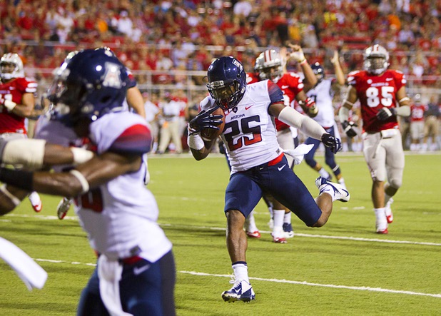 University of Arizona's Ka'Deem Carey scores during UNLV's home opener against the University of Arizona at Sam Boyd Stadium Saturday, Sept. 7, 2013.