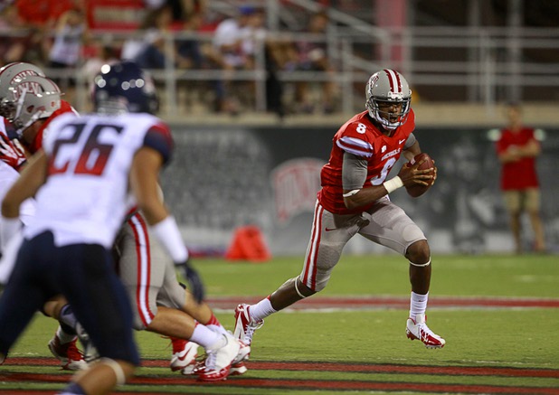 UNLV quarterback Caleb Herring (8) scrambles during UNLV's home opener against the University of Arizona at Sam Boyd Stadium Saturday, Sept. 7, 2013.