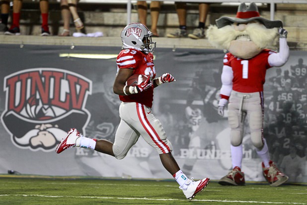 UNLV running back Shaquille Murray-Lawrence carries the ball into the end zone for a 79-yard touchdown run during UNLV's home opener against the University of Arizona at Sam Boyd Stadium Saturday, Sept. 7, 2013.