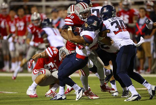 UNLV defensive lineman Parker Holloway shuts down a kickoff turn by University of Arizona's Nate Phillips during UNLV's home opener against UA at Sam Boyd Stadium Saturday, Sept. 7, 2013.