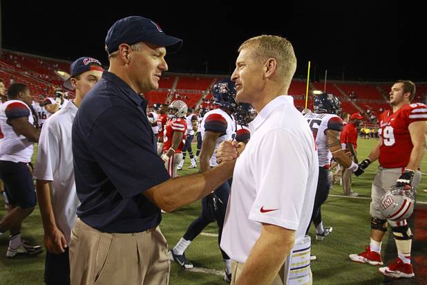 UNLV head coach Bobby Hauck, right, congratulates University of Arizona head coach Rich Rodriguez after UNLV's home opener against Arizona at Sam Boyd Stadium on Saturday, Sept. 7, 2013.