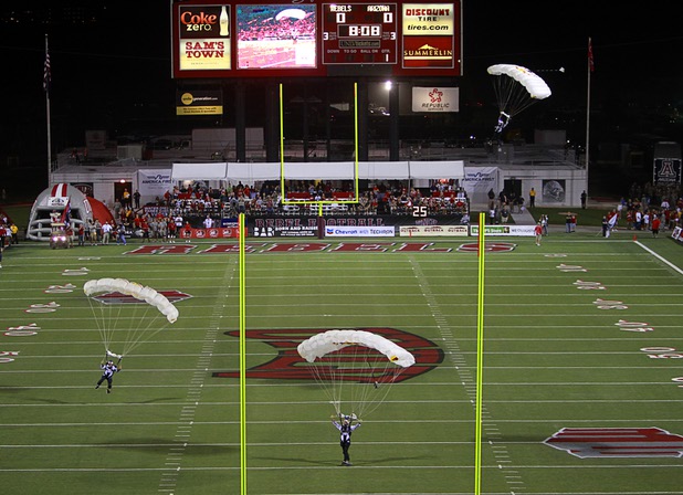 Members of the Red Bull skydiving team land on the field before UNLV's home opener against the University of Arizona at Sam Boyd Stadium Saturday, Sept. 7, 2013.