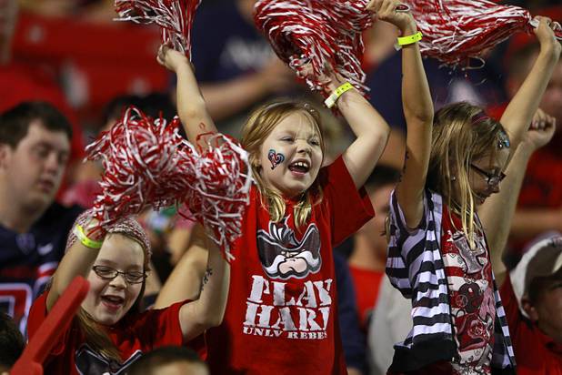Rebels fan cheer for UNLV during the team's home opener against the University of Arizona at Sam Boyd Stadium on Saturday, Sept. 7, 2013.