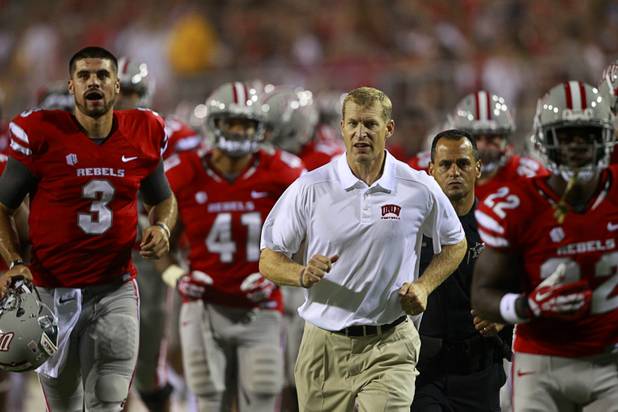 UNLV head coach Bobby Hauck heads to the locker room with the team at the end of the first half during UNLV's home opener against the University of Arizona at Sam Boyd Stadium Saturday, Sept. 7, 2013.