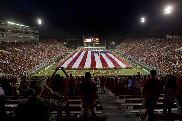 A giant American flag is unfurled before UNLV's home opener against the University of Arizona at Sam Boyd Stadium Saturday, Sept. 7, 2013.
