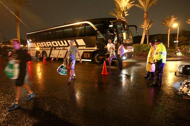 Athletes arrive at Lake Las Vegas by bus before dawn for the Ironman 70.3 World Championship in Henderson Sunday, Sept. 8, 2013. More than 1,800 athletes from around the U.S. and 53 countries qualified for the event.