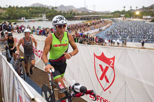 Ivan Vasiliev of Russia heads to the road course after completing his swim during the Ironman 70.3 World Championship at Lake Las Vegas in Henderson Sunday, Sept. 8, 2013. More than 1,800 athletes from around the U.S. and 53 countries qualified for the event.