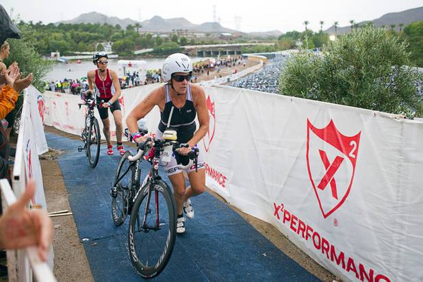 Margaret Hepworth, center, of Boise, Idaho heads to the road course to begin a 56-mile bike ride during the Ironman 70.3 World Championship in Henderson Sunday, Sept. 8, 2013. More than 1,800 athletes from around the U.S. and 53 countries qualified for the event.