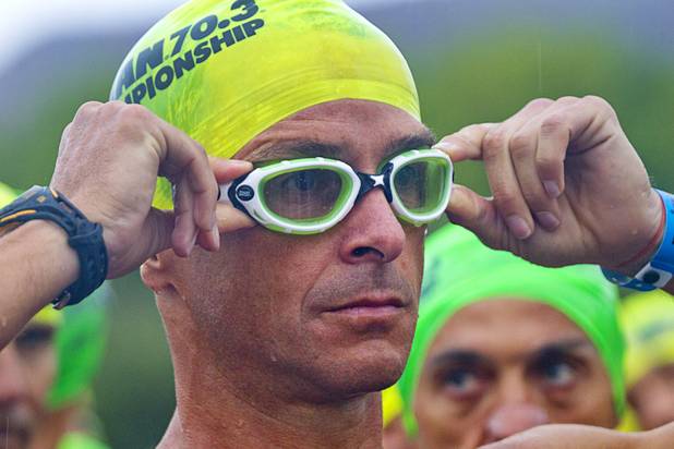A man in the 40 to 44-year-old division adjusts his goggles  as he prepares for a 1.2-mile swim during the Ironman 70.3 World Championship at Lake Las Vegas in Henderson Sunday, Sept. 8, 2013. More than 1,800 athletes from around the U.S. and 53 countries qualified for the event.