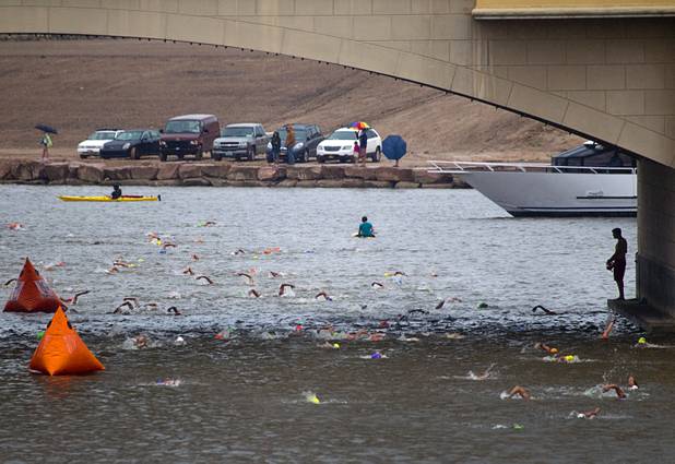 A lifeguard keeps watch at right as athletes finish a 1.2-mile swim during the Ironman 70.3 World Championship at Lake Las Vegas in Henderson Sunday, Sept. 8, 2013. More than 1,800 athletes from around the U.S. and 53 countries qualified for the event.