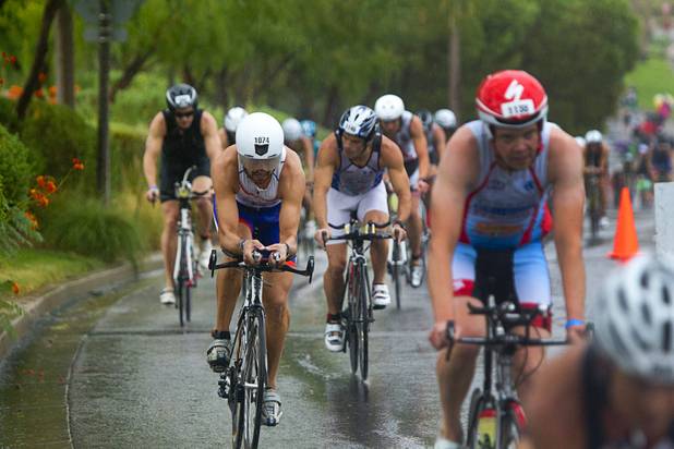 Athletes ride uphill from Lake Las Vegas during the Ironman 70.3 World Championship in Henderson Sunday, Sept. 8, 2013. More than 1,800 athletes from around the U.S. and 53 countries qualified for the event. Juan Daniel Hernandez of Spain (1074) is at left.