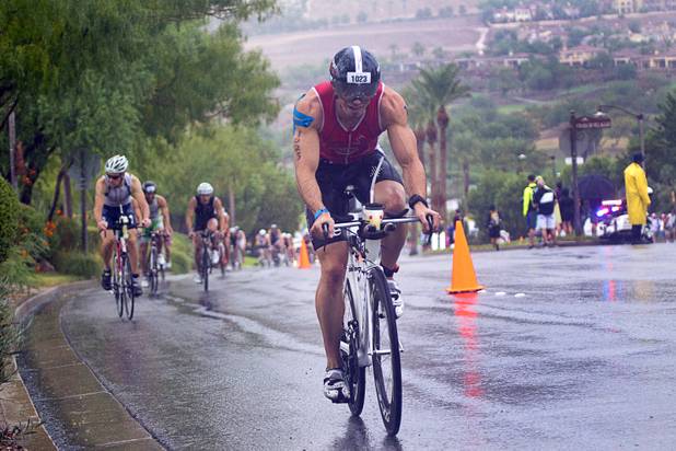 Nicolas Debons of Switzerland rides uphill from Lake Las Vegas during the Ironman 70.3 World Championship in Henderson Sunday, Sept. 8, 2013. More than 1,800 athletes from around the U.S. and 53 countries qualified for the event.