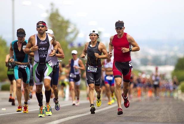 Athletes run uphill Green Valley Parkway toward Horizon Ridge Parkway during the Ironman 70.3 World Championship in Henderson Sunday, Sept. 8, 2013. The 13.1 mile run comes after a 56-mile bicycle course and a 1.2-mile swim in Las Las Vegas. More than 1,800 athletes from around the U.S. and 53 countries qualified for the event.