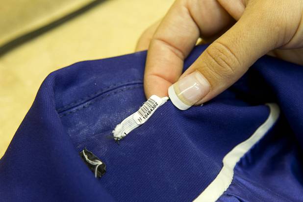 Edith Aguirre displays a barcode on a costume at Tiffany Cleaners in the Commercial Center Monday, Sept. 9, 2013. Barcodes let the cleaners track the costume and make notes in the computer of any pre-existing damage. In addition to serving their normal dry cleaning customers, the shop also provides dry cleaning for most of the shows on the Las Vegas Strip.